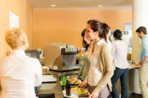 Cafeteria woman pay at cashier hold serving tray fresh food