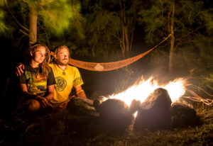 Campfire on a rocky beach with a couple  sitting