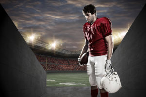 Football Player with a red uniform on a tunnel to a stadium.